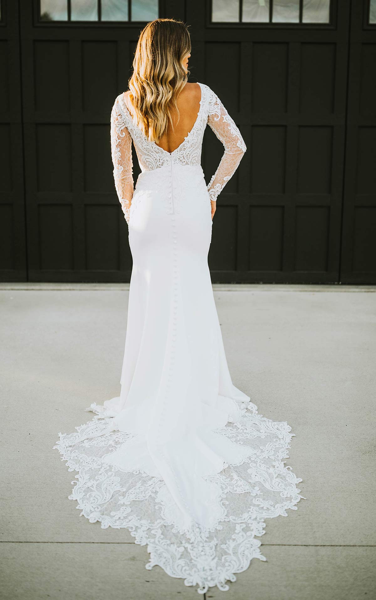 Timeless V back long sleeved wedding gown with scalloped hem and lace motifs