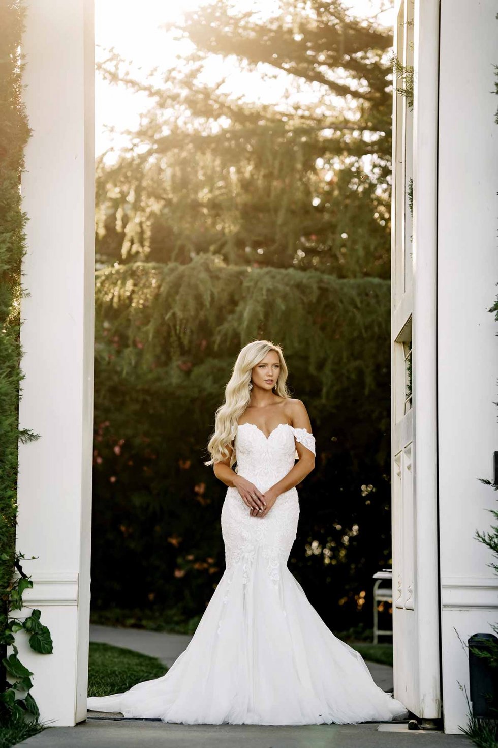 Fishtail wedding dress with off the shoulder straps and lace detail 
